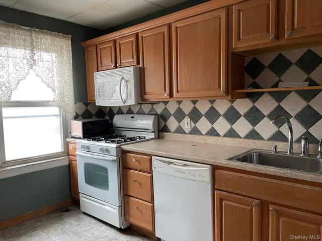 a kitchen with a stove a sink and a microwave