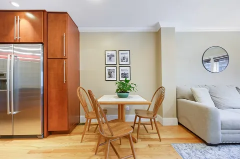 a dining room with furniture and window