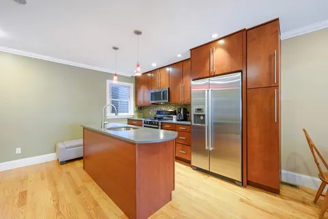 a kitchen with stainless steel appliances a refrigerator and a stove