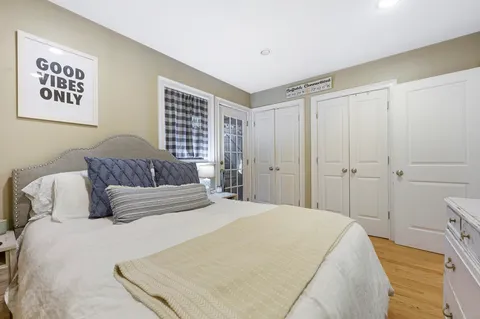 a bedroom with a large bed and a chandelier