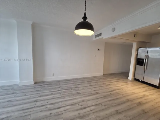 a view of a room with wooden floor