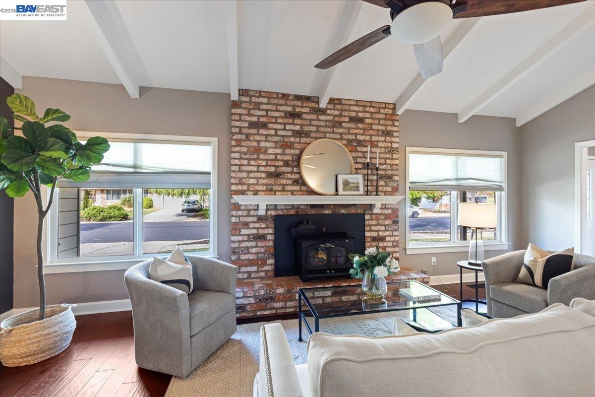 a living room with furniture a fireplace and a potted plant