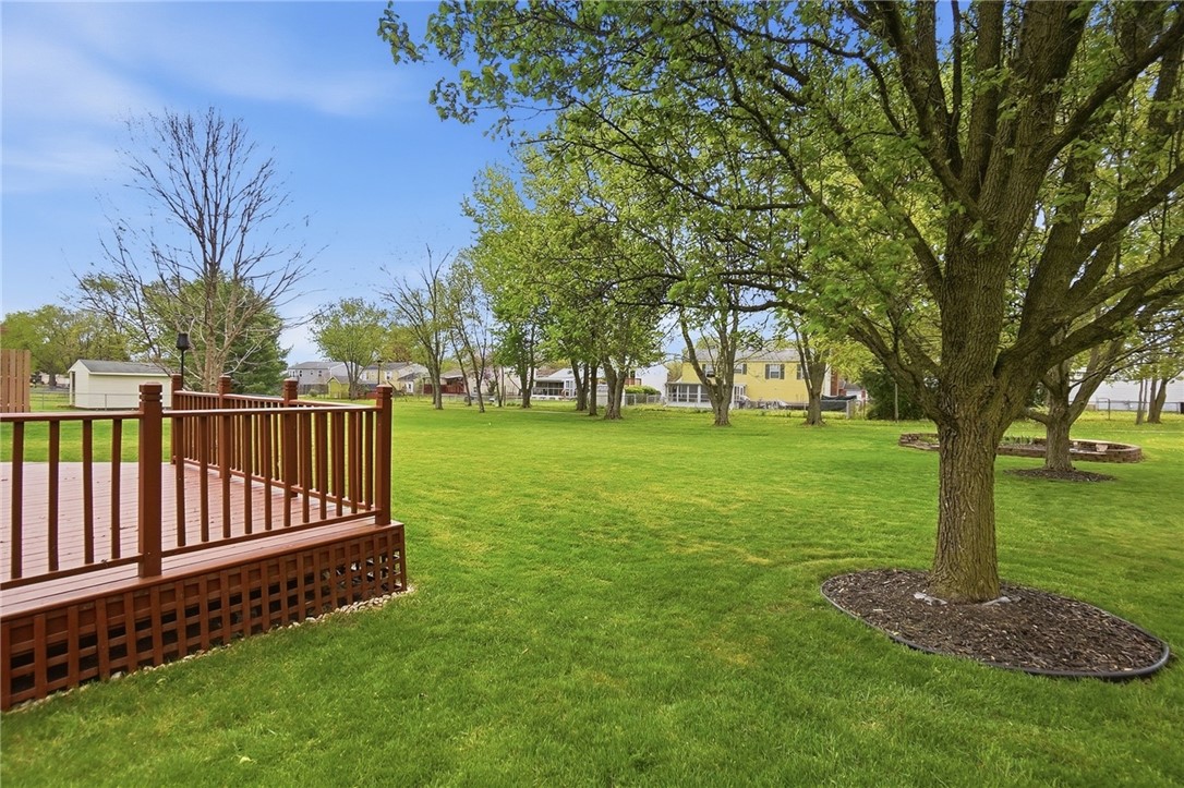 135 Concord Farm Road Englewood, OH 45322 - Photo 45 of 46 This expansive backyard offers a perfect blend of lush greenery and outdoor entertaining space.