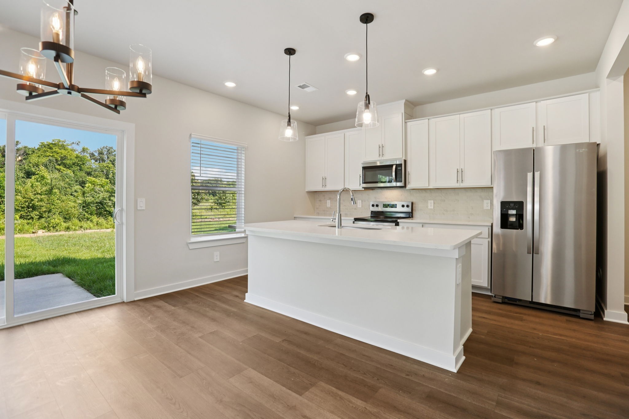 3823 Hallanday Drive Murfreesboro, TN 37128 - Photo 17 of 59 a kitchen with stainless steel appliances granite countertop a refrigerator a oven a sink and white cabinets with wooden floor