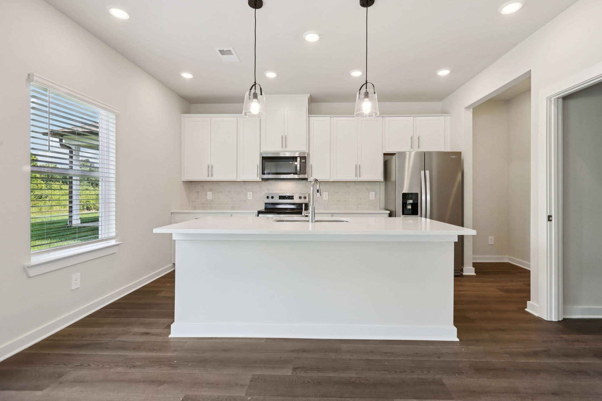 3823 Hallanday Drive Murfreesboro, TN 37128 - Photo 20 of 59 a large white kitchen with stainless steel appliances granite countertop a stove a refrigerator a sink and a oven with wooden floor