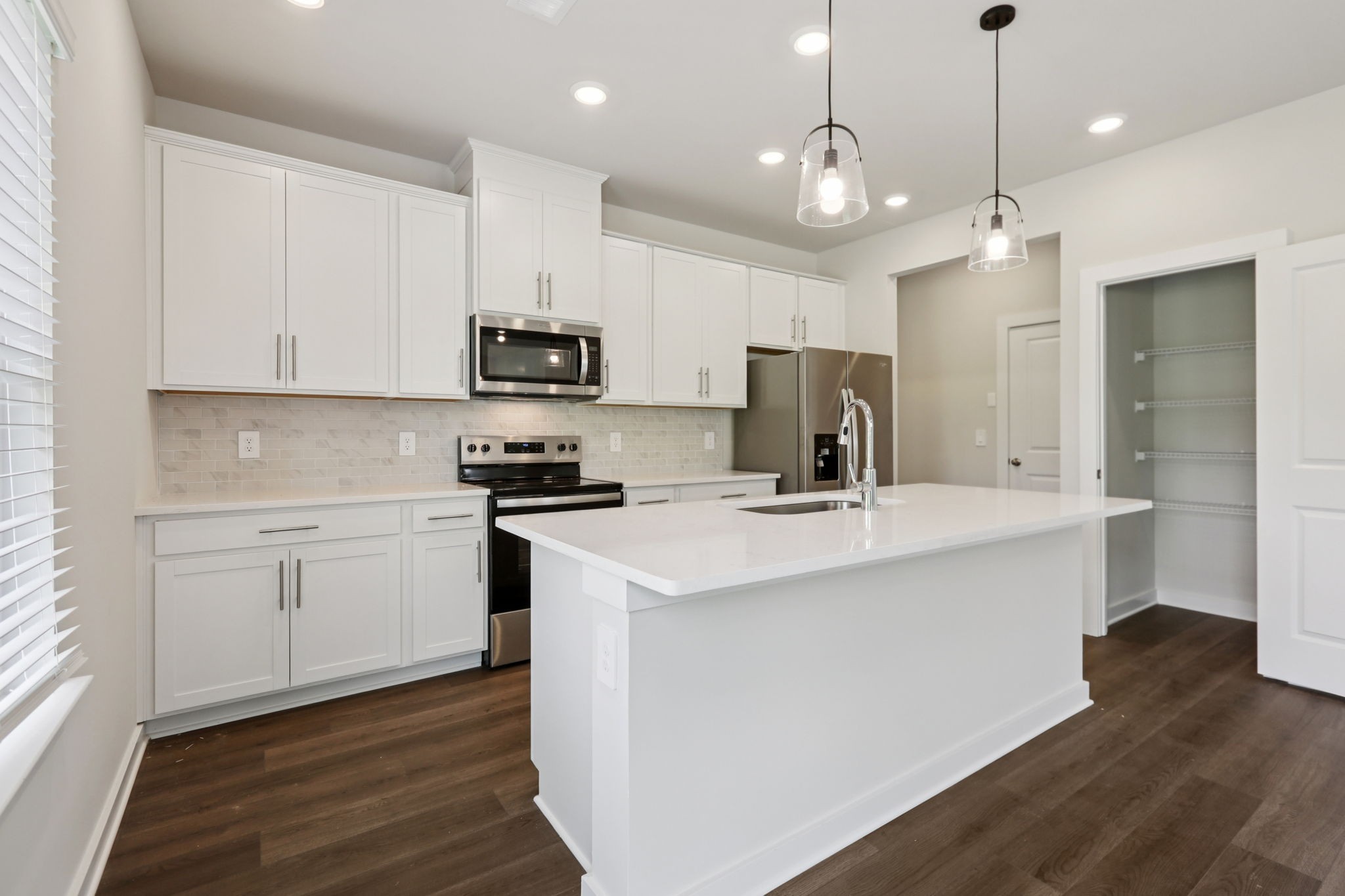 3823 Hallanday Drive Murfreesboro, TN 37128 - Photo 21 of 59 a kitchen with kitchen island a sink and a stove with wooden floor