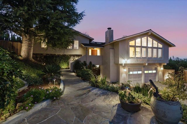 a front view of a house with a yard and outdoor seating