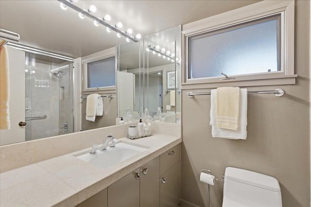 a bathroom with a sink a toilet and a mirror