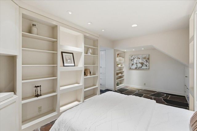 a bedroom with a bed and a cabinets