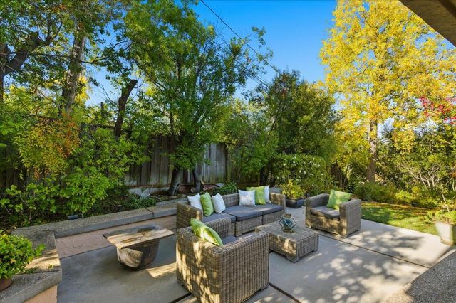 a view of a patio with table and chairs and potted plants