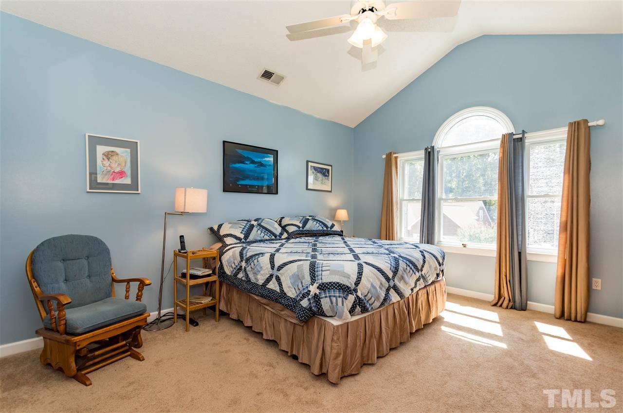 5232 Knightsbridge Way Raleigh, NC 27604 - Photo 14 of 25 a bed sitting in a spacious bedroom next to a window