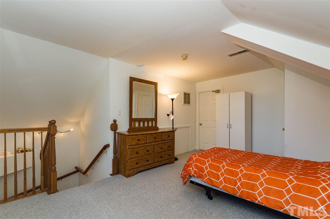 5232 Knightsbridge Way Raleigh, NC 27604 - Photo 22 of 25 a bed room with a bed and a dresser