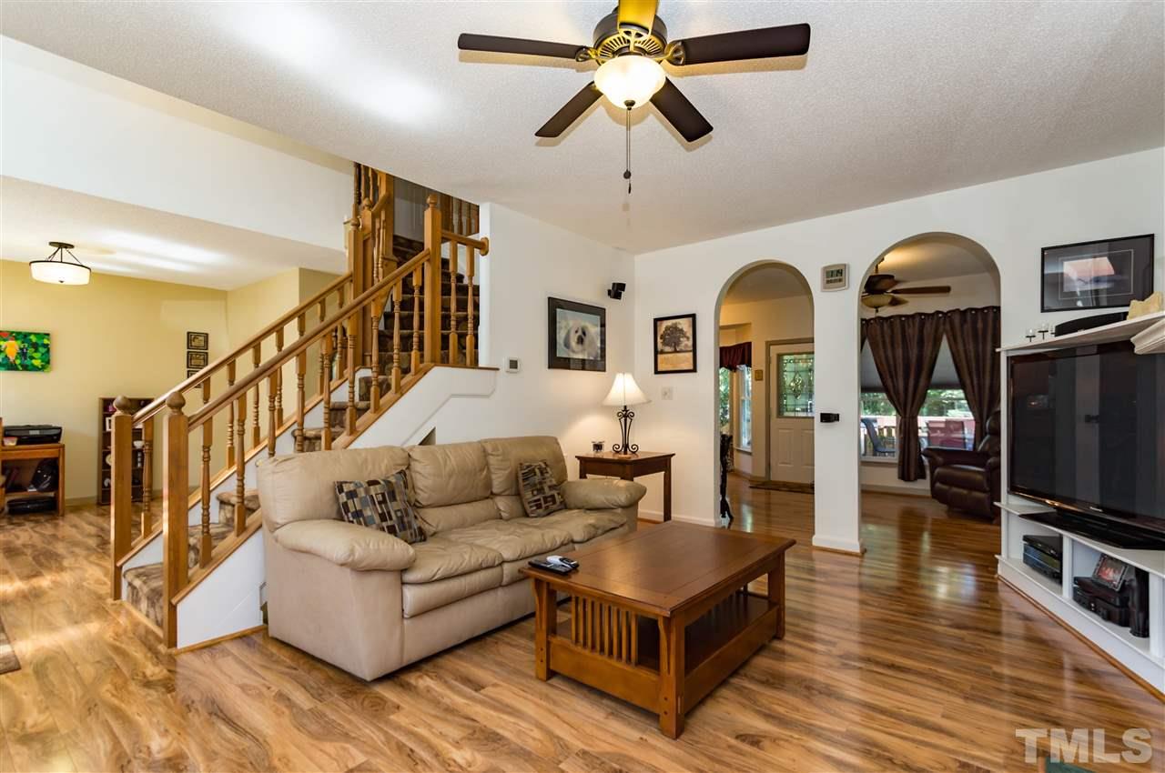 5232 Knightsbridge Way Raleigh, NC 27604 - Photo 6 of 25 a living room with furniture ceiling fan and a wooden floor