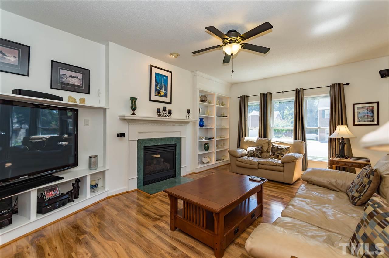 5232 Knightsbridge Way Raleigh, NC 27604 - Photo 7 of 25 a living room with furniture a flat screen tv and a fireplace