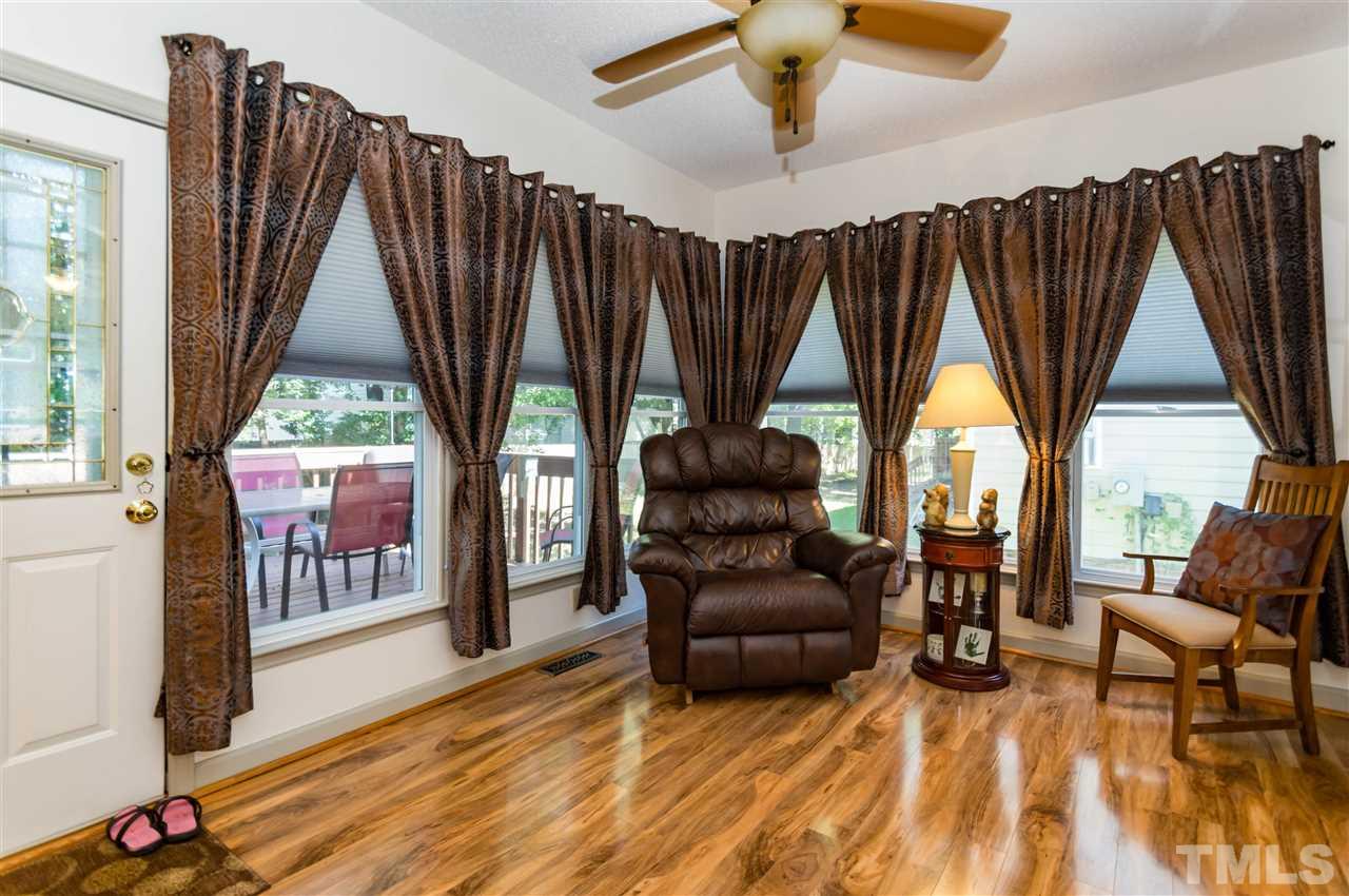 5232 Knightsbridge Way Raleigh, NC 27604 - Photo 8 of 25 a living room with furniture a bed and a large window