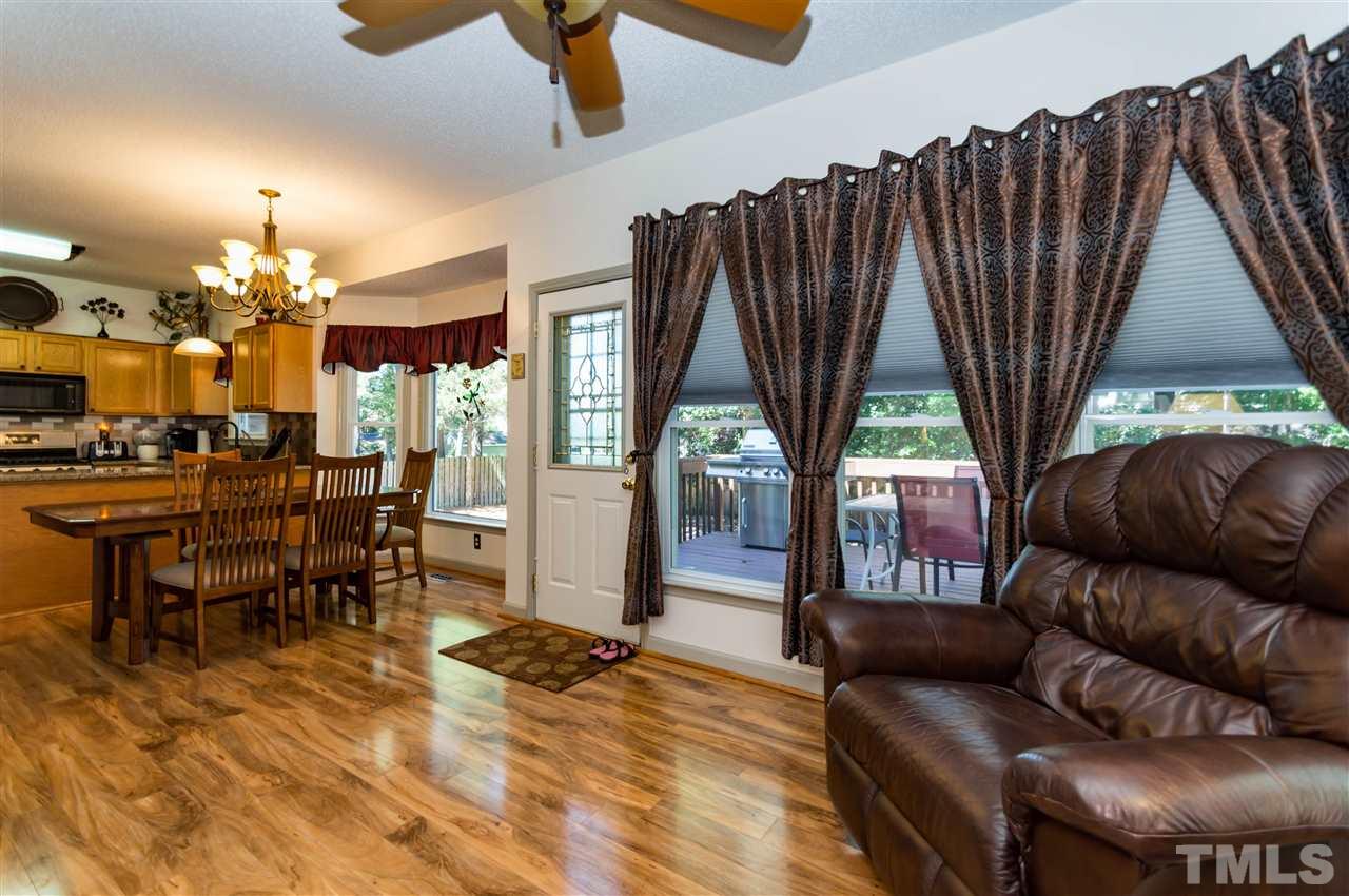 5232 Knightsbridge Way Raleigh, NC 27604 - Photo 9 of 25 a living room with furniture a fireplace and a large window