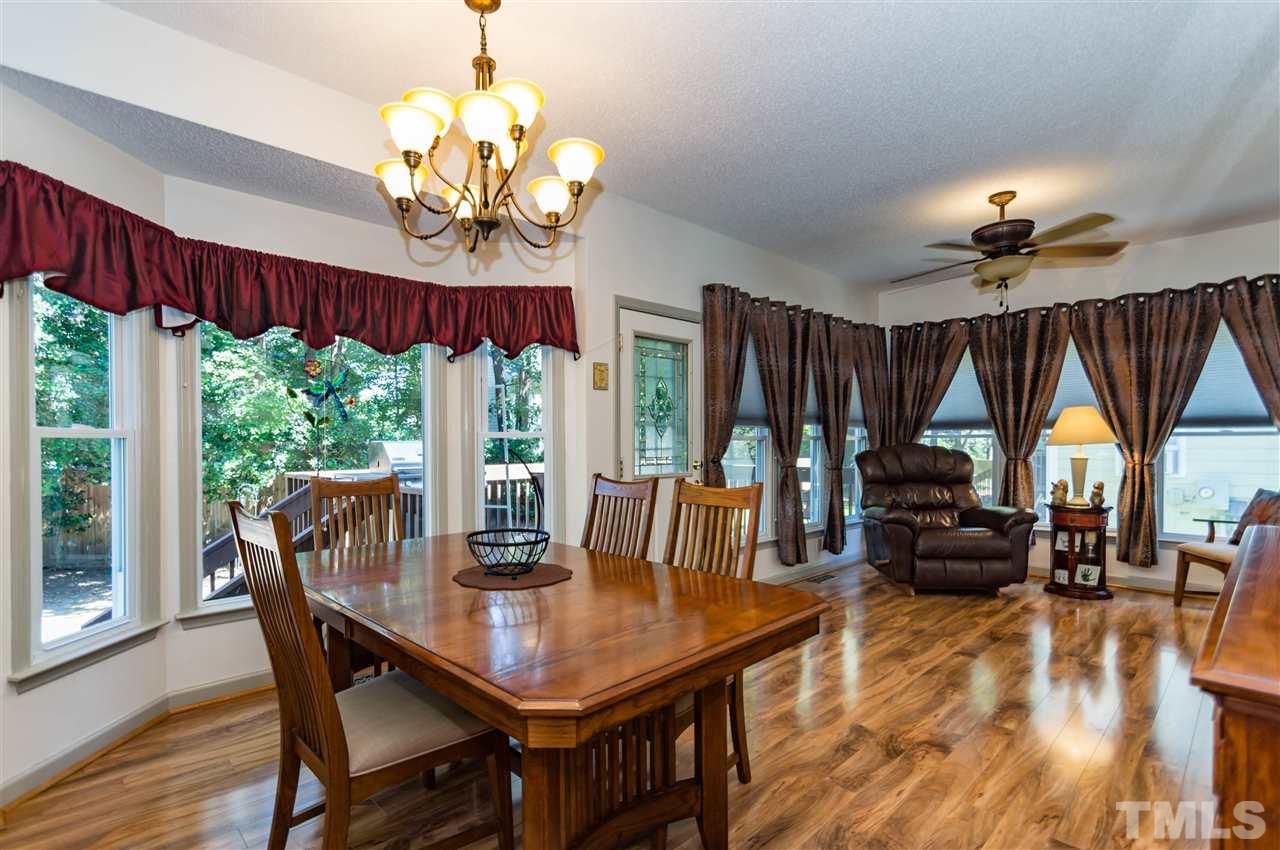 5232 Knightsbridge Way Raleigh, NC 27604 - Photo 10 of 25 a view of a dining room with furniture a chandelier and wooden floor