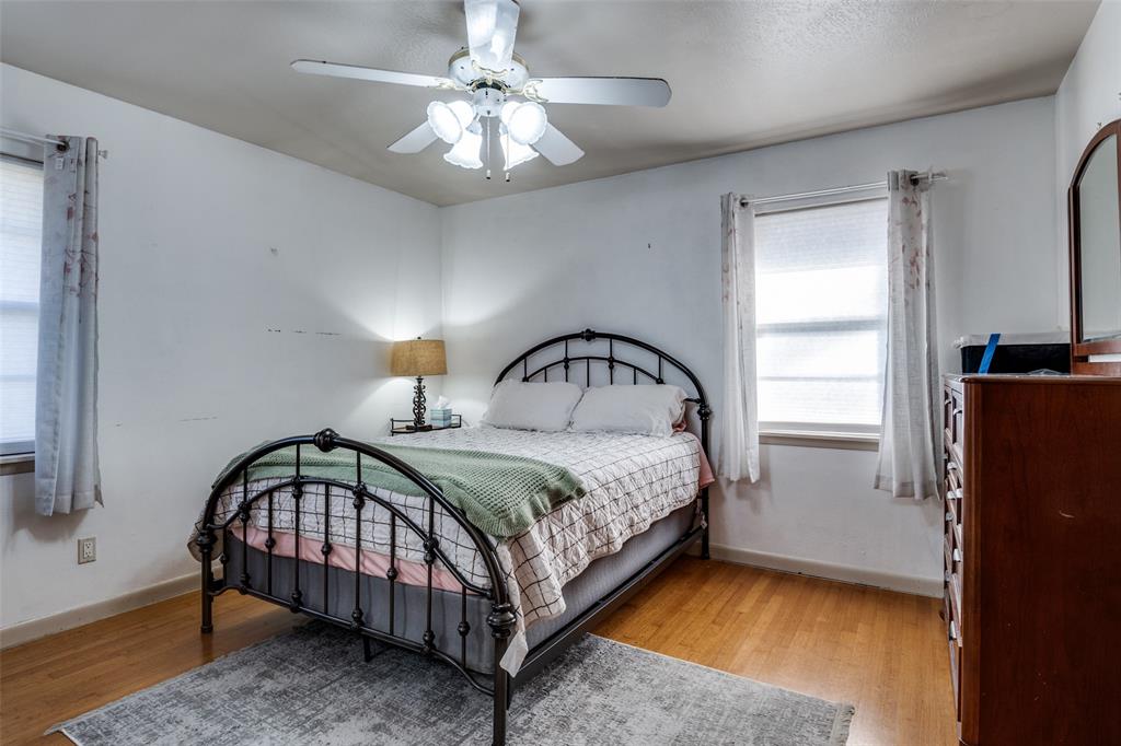 2602 Ridgecrest Drive Garland, TX 75041 - Photo 12 of 24 a bedroom with a bed window and a table