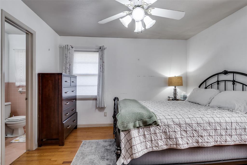 2602 Ridgecrest Drive Garland, TX 75041 - Photo 13 of 24 a bedroom with a bed and wooden floor