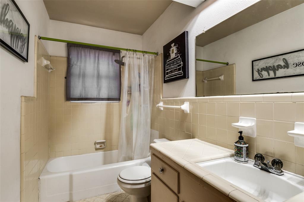 2602 Ridgecrest Drive Garland, TX 75041 - Photo 14 of 24 a bathroom with a sink toilet and shower