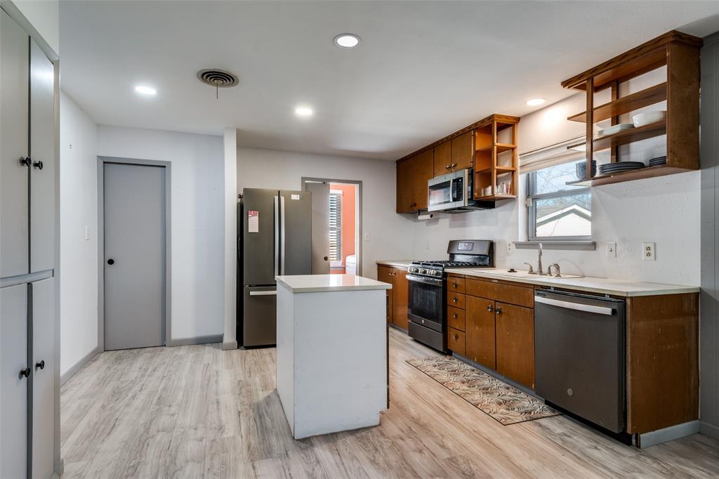2602 Ridgecrest Drive Garland, TX 75041 - Photo 10 of 24 a kitchen with sink cabinets and wooden floor