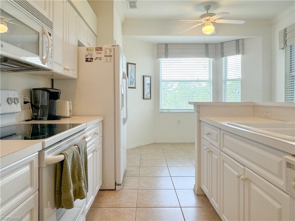3820 Sawgrass Way, Unit 3046 Naples, FL 34112 - Photo 24 of 50 a kitchen with a refrigerator a sink and dishwasher