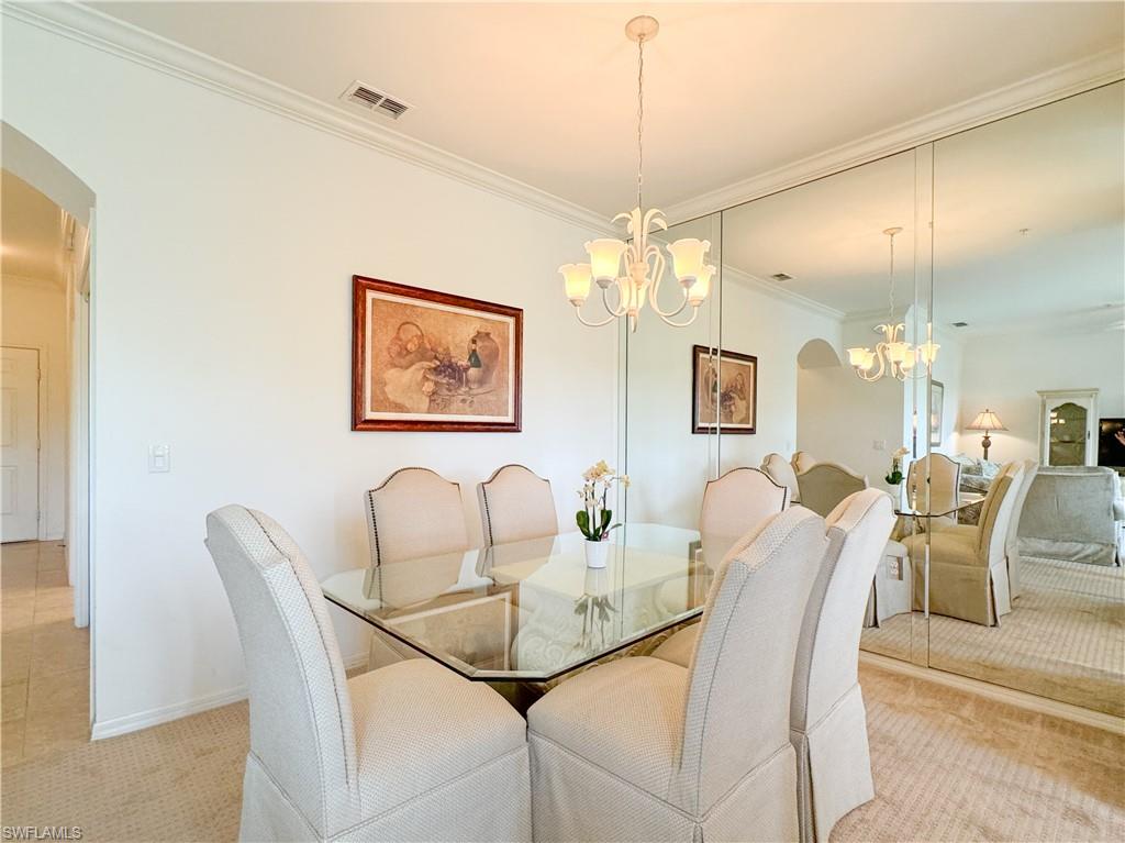 3820 Sawgrass Way, Unit 3046 Naples, FL 34112 - Photo 27 of 50 a dining room with furniture and chandelier