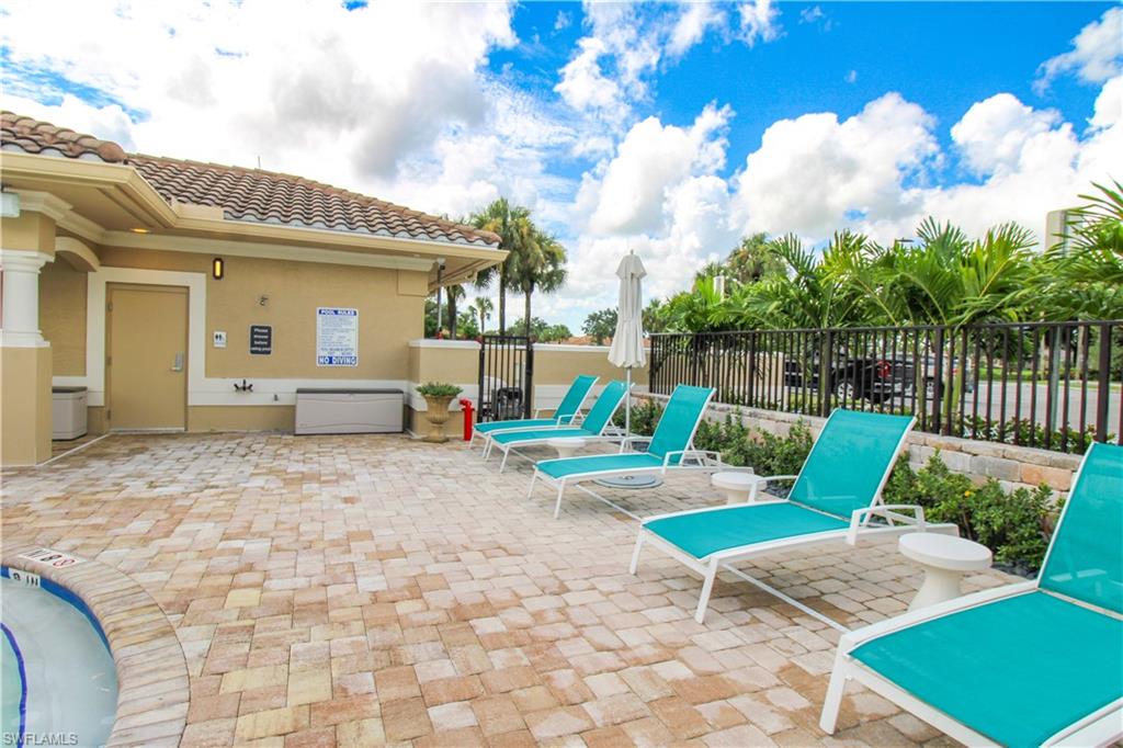 3820 Sawgrass Way, Unit 3046 Naples, FL 34112 - Photo 36 of 50 a view of a house with backyard and furniture