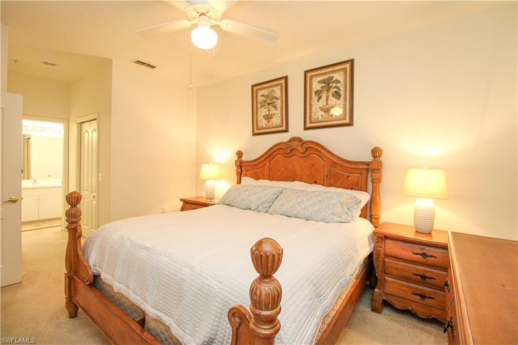 3820 Sawgrass Way, Unit 3046 Naples, FL 34112 - Photo 4 of 50 a bedroom with a bed and a painting on the wall