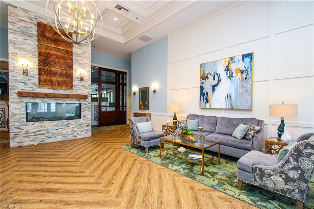 3820 Sawgrass Way, Unit 3046 Naples, FL 34112 - Photo 48 of 50 a living room with furniture and a fireplace