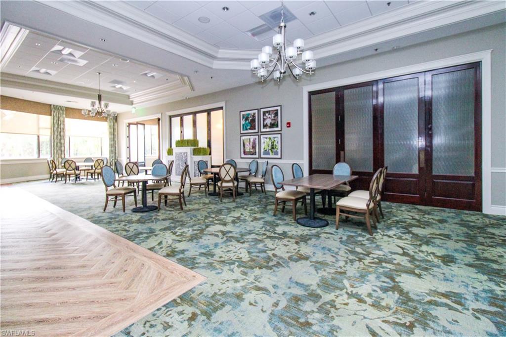 3820 Sawgrass Way, Unit 3046 Naples, FL 34112 - Photo 49 of 50 a view of a dining room with furniture window and wooden floor