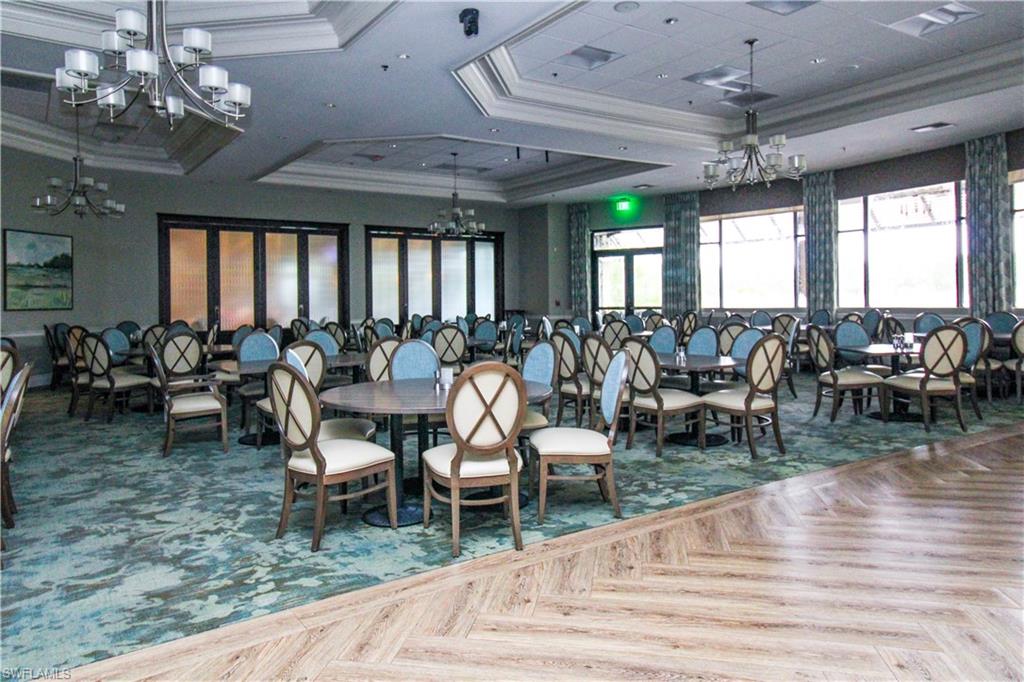 3820 Sawgrass Way, Unit 3046 Naples, FL 34112 - Photo 50 of 50 a view of a dining room with furniture window and wooden floor