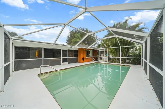a view of a backyard with a swimming pool