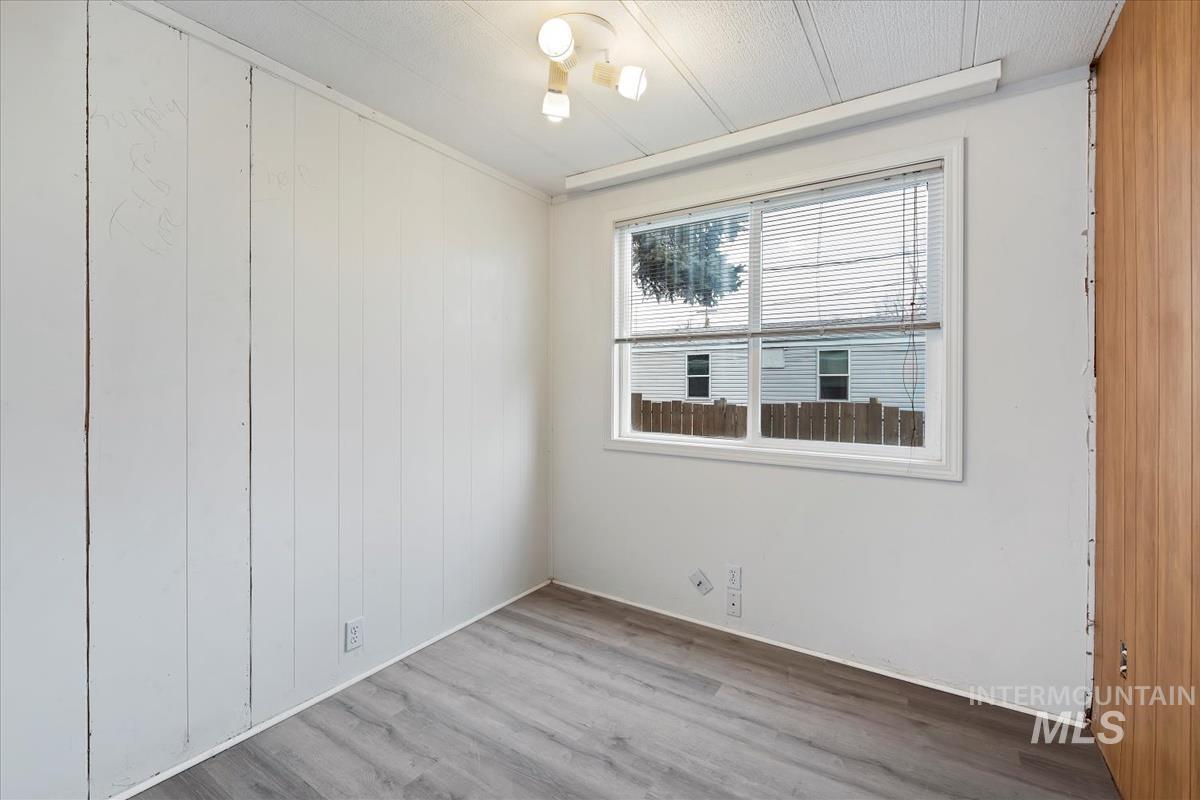 10167 Maymie Road Boise, ID 83714 - Photo 15 of 31 bedroom 2 with wood finished floors and wooden walls