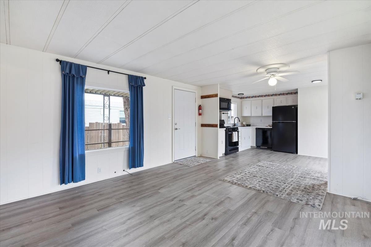 10167 Maymie Road Boise, ID 83714 - Photo 6 of 31 Unfurnished living room with light wood finished floors and ceiling fan