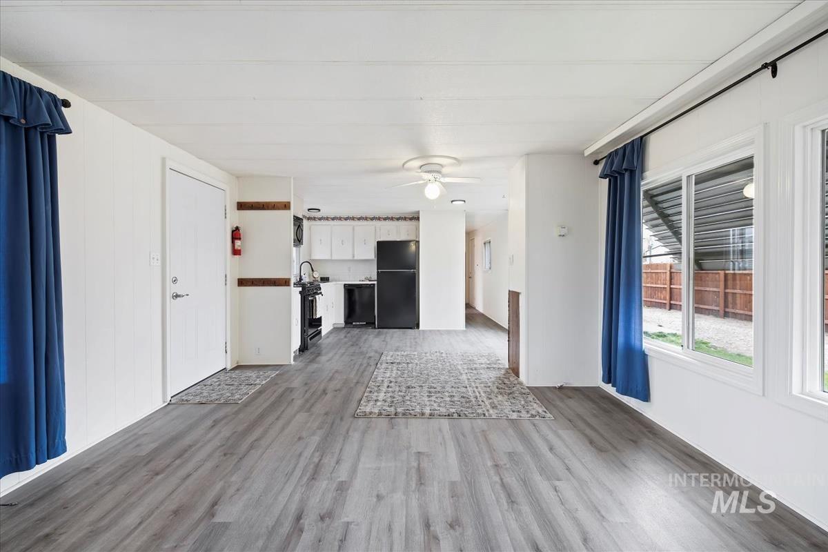 10167 Maymie Road Boise, ID 83714 - Photo 7 of 31 Unfurnished living room with light wood-style flooring and a ceiling fan