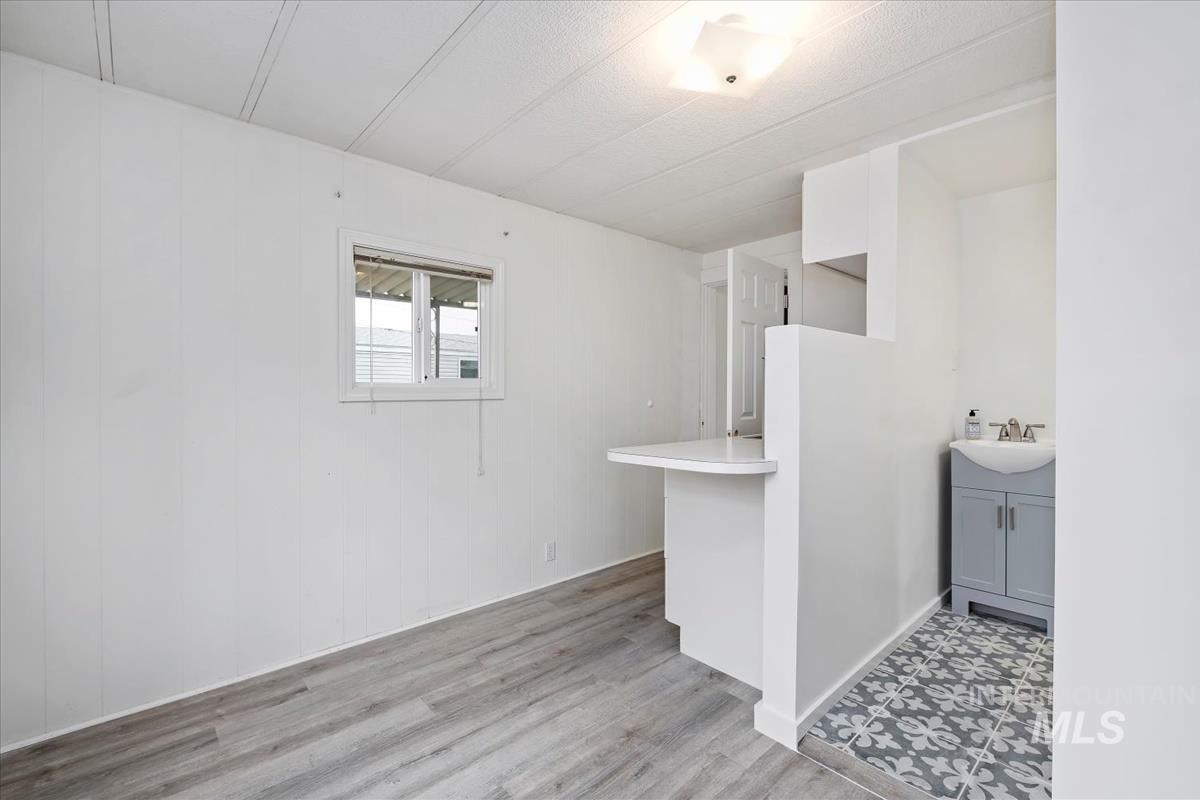10167 Maymie Road Boise, ID 83714 - Photo 8 of 31 Bar area with light countertops and light wood finished floors