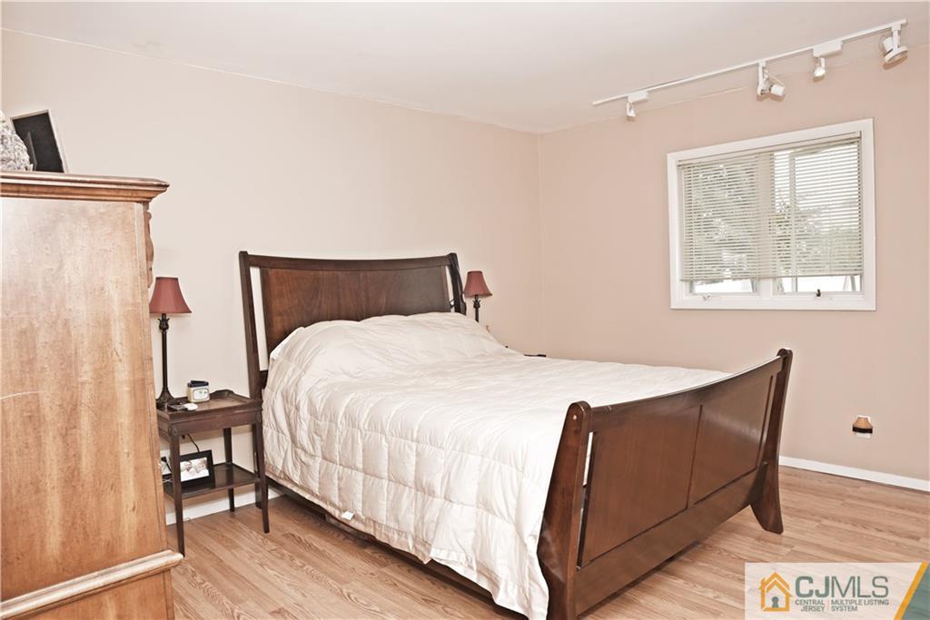 58 Princeton Road Old Bridge, NJ 08859 - Photo 11 of 24 a bed room with a bed and a night stand