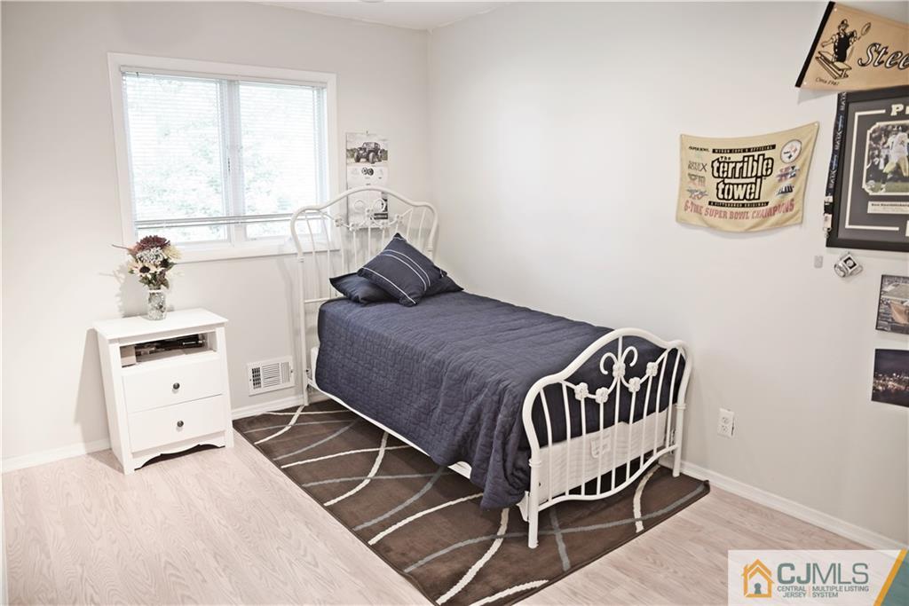 58 Princeton Road Old Bridge, NJ 08859 - Photo 16 of 24 a bedroom with a bed and wooden floor