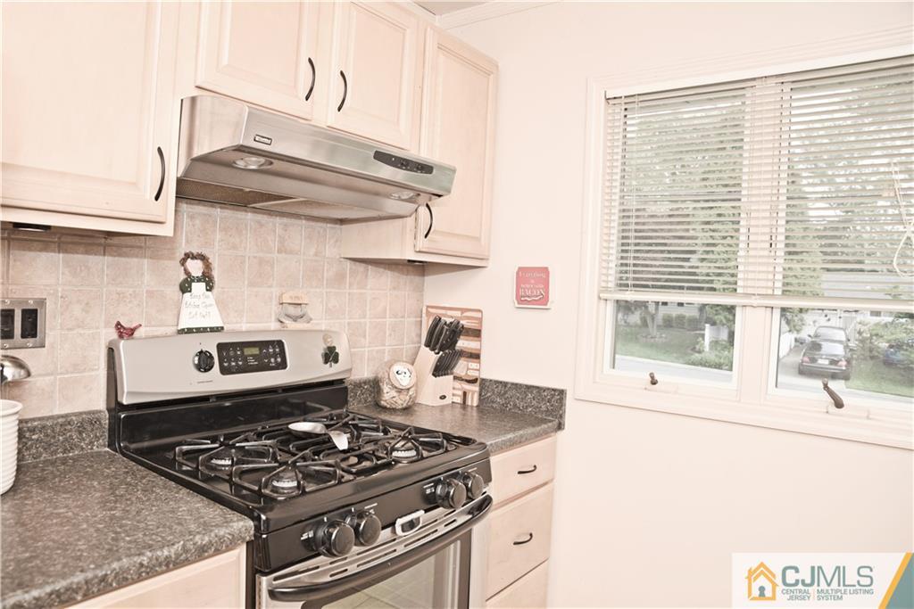 58 Princeton Road Old Bridge, NJ 08859 - Photo 8 of 24 a kitchen with granite countertop a stove and a white refrigerator