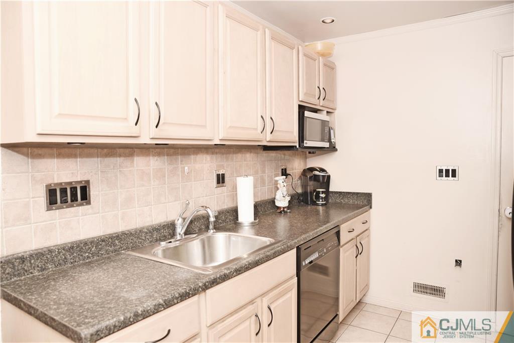 58 Princeton Road Old Bridge, NJ 08859 - Photo 9 of 24 a kitchen with stainless steel appliances granite countertop a sink stove and cabinets