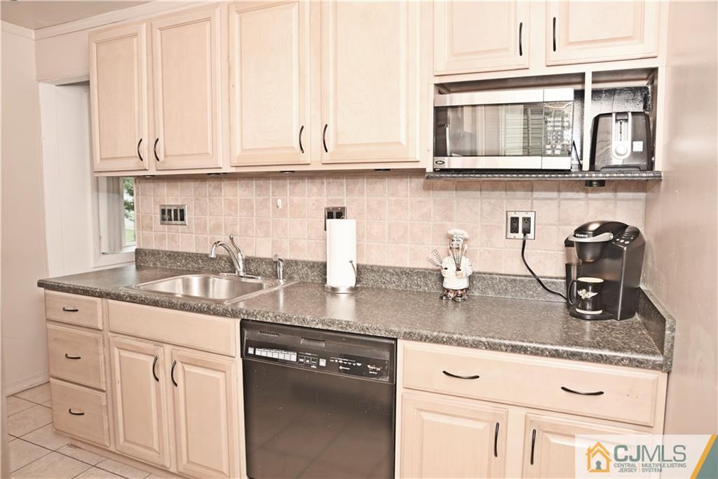 58 Princeton Road Old Bridge, NJ 08859 - Photo 10 of 24 a kitchen with granite countertop stainless steel appliances granite countertop white cabinets and a sink