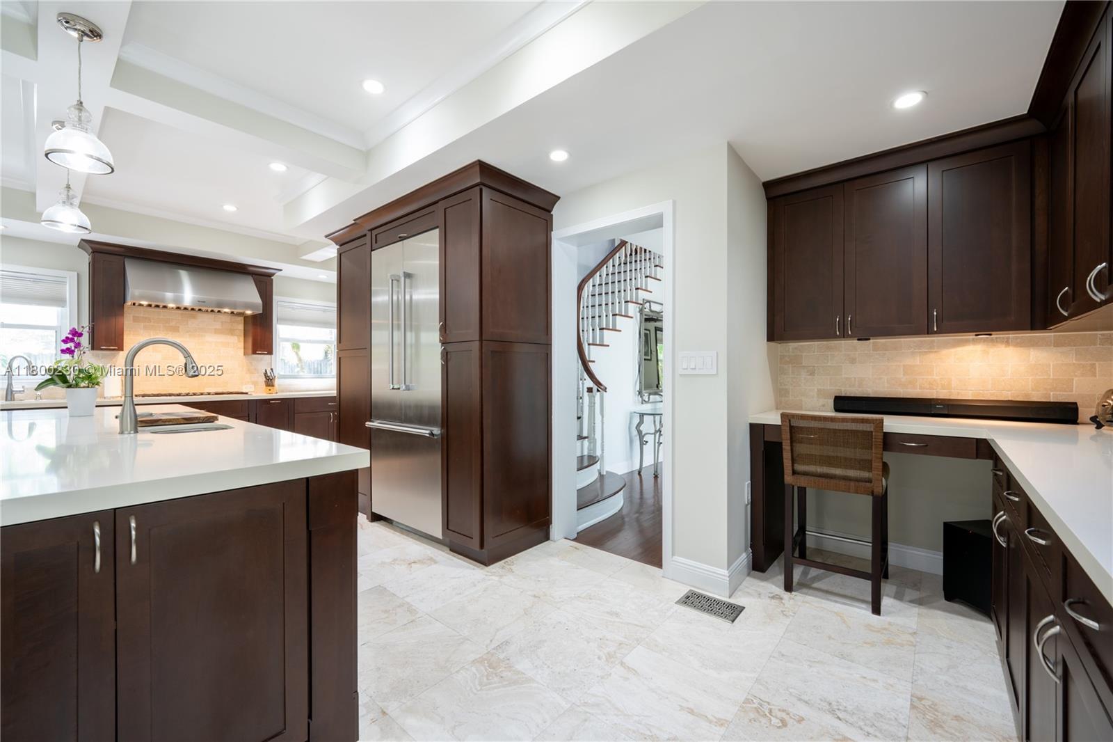 2855 Southwest 17th Avenue Miami, FL 33133 - Photo 11 of 84 a kitchen with stainless steel appliances kitchen island granite countertop a refrigerator and a sink