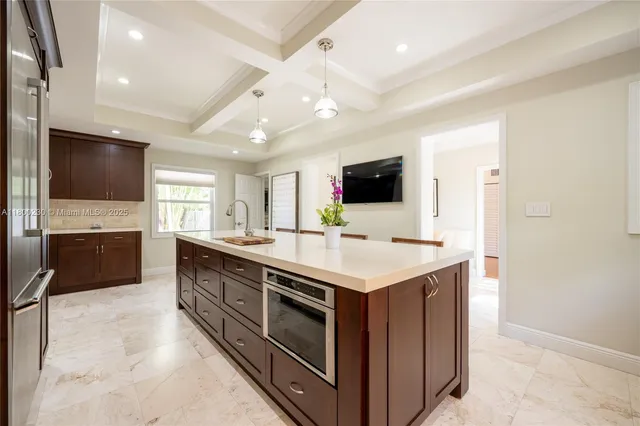 a kitchen with kitchen island a sink stainless steel appliances and cabinets