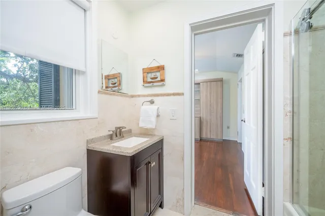 a view of a dining room with furniture and a chandelier
