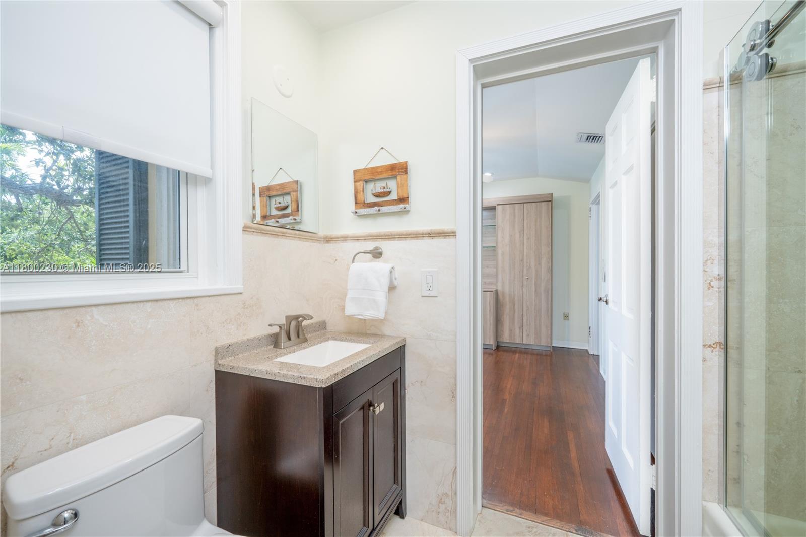 2855 Southwest 17th Avenue Miami, FL 33133 - Photo 37 of 84 a bathroom with a toilet sink and mirror