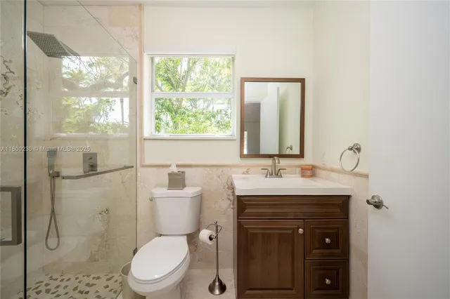 a bathroom with a sink double vanity and a large mirror