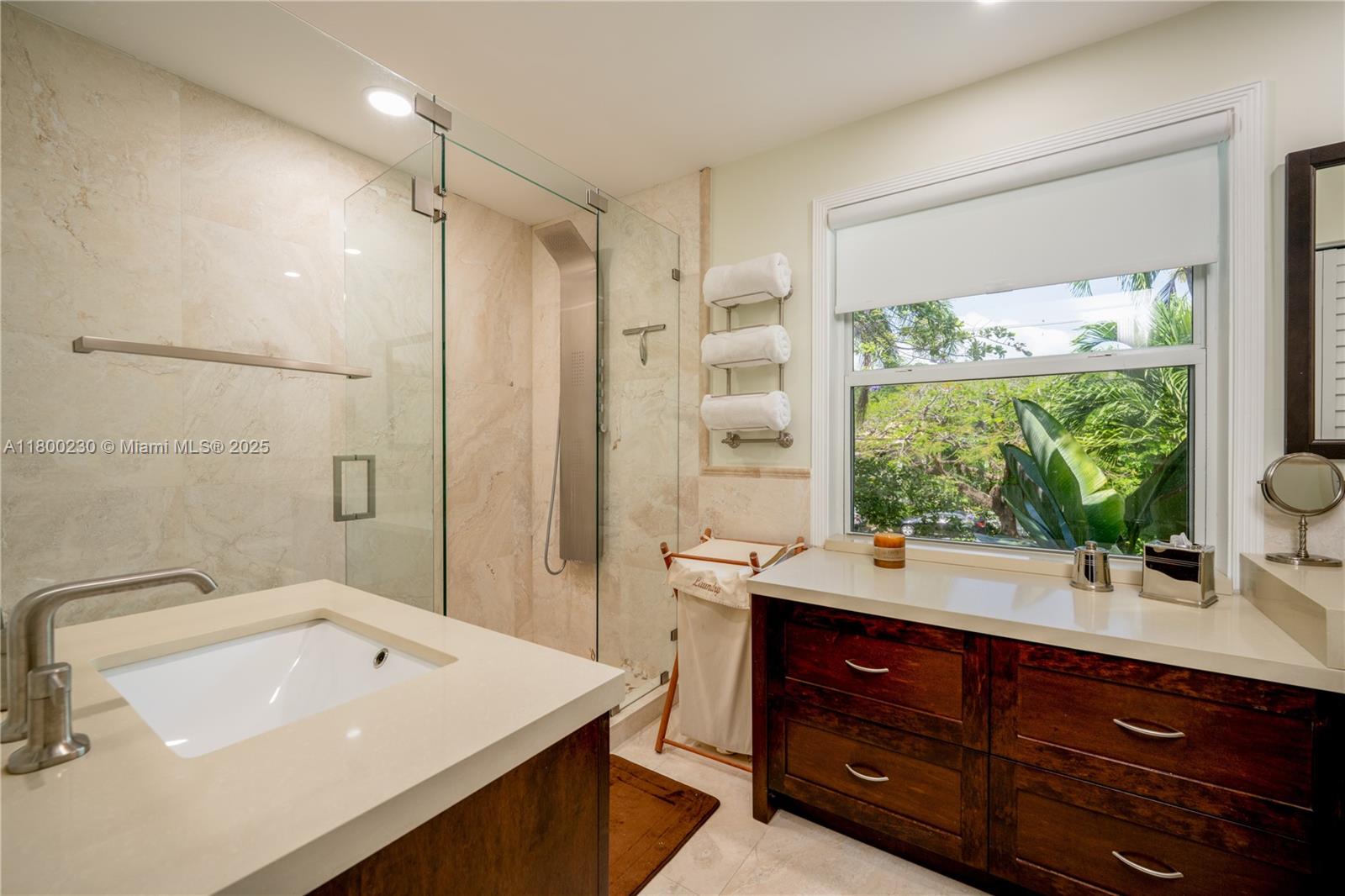 2855 Southwest 17th Avenue Miami, FL 33133 - Photo 55 of 84 a bathroom with a sink double vanity and a large mirror