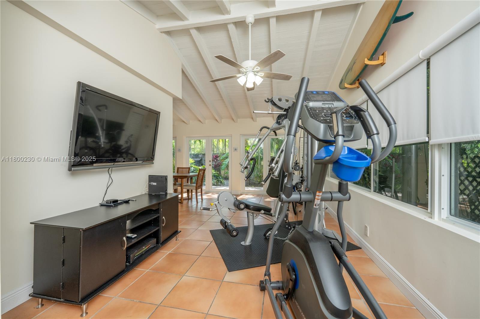 2855 Southwest 17th Avenue Miami, FL 33133 - Photo 7 of 84 a view of a workspace with furniture and a flat screen tv