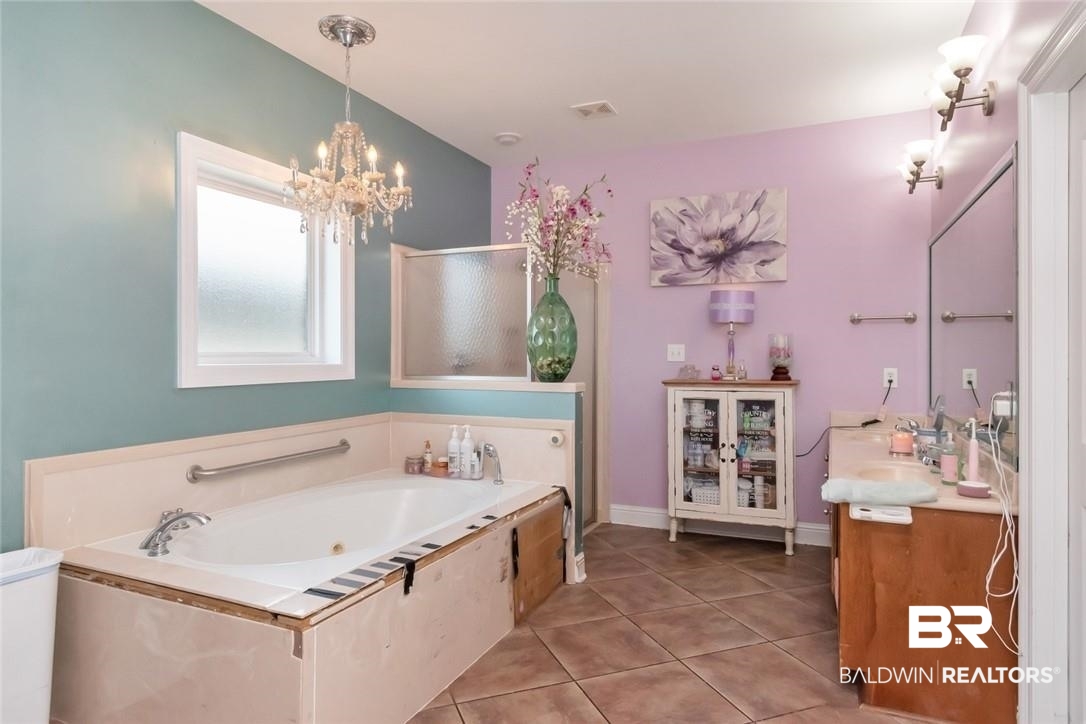 7170 Pierson Drive Mobile, AL 36619 - Photo 13 of 29 Bathroom featuring tile patterned flooring, a chandelier, vanity, and a bathing tub